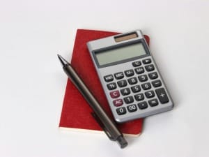 A picture showing a calculator and a pen.
