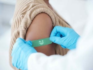 A picture of a healthcare professional applying a System C plaster to a patient.