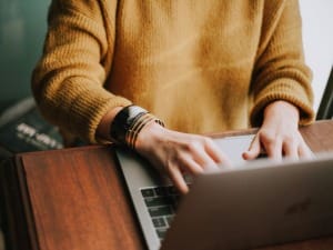 a picture of a person on a laptop using online financial assessments.