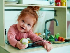 A picture of a young child smiling at the camera.