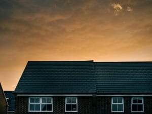 A picture of a home in the UK with a warm orange sky in the background.