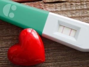 A picture of a pregnancy test with a System C logo.