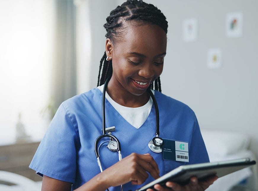 A female healthcare worker using careFlow EPR on a tablet device.