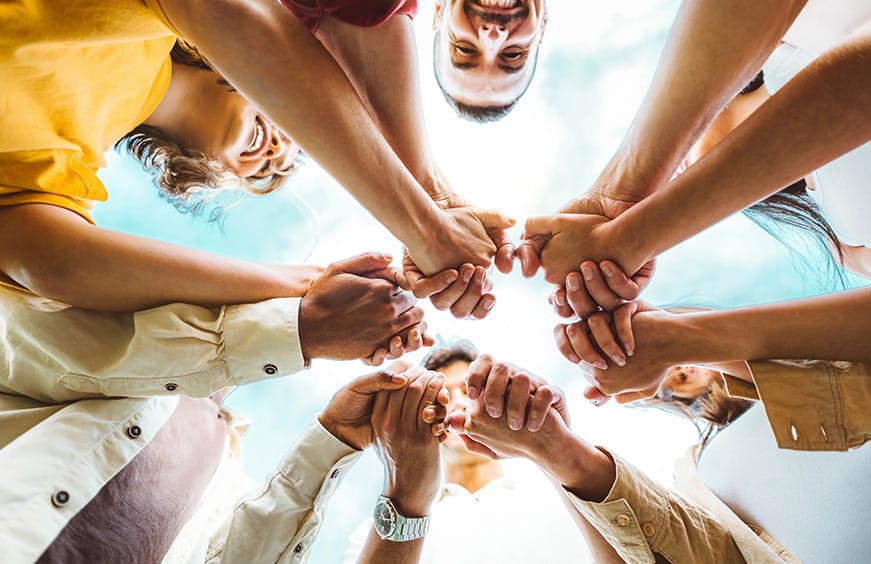 System C team holding hands
