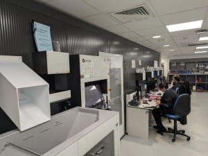 An image which shows some people sat at the robot using CareFlow Medicines Management to dispense medicine.