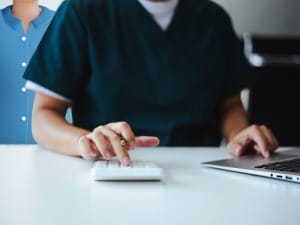 A picture of a healthcare professional accessing our electronic patient record calculator on a laptop.