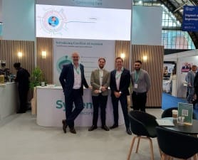 A smiling System C team in-front of our NHS ConfedExpo Stand