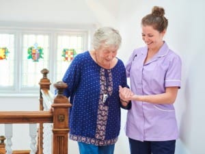 A social worker helping an elderly lady.