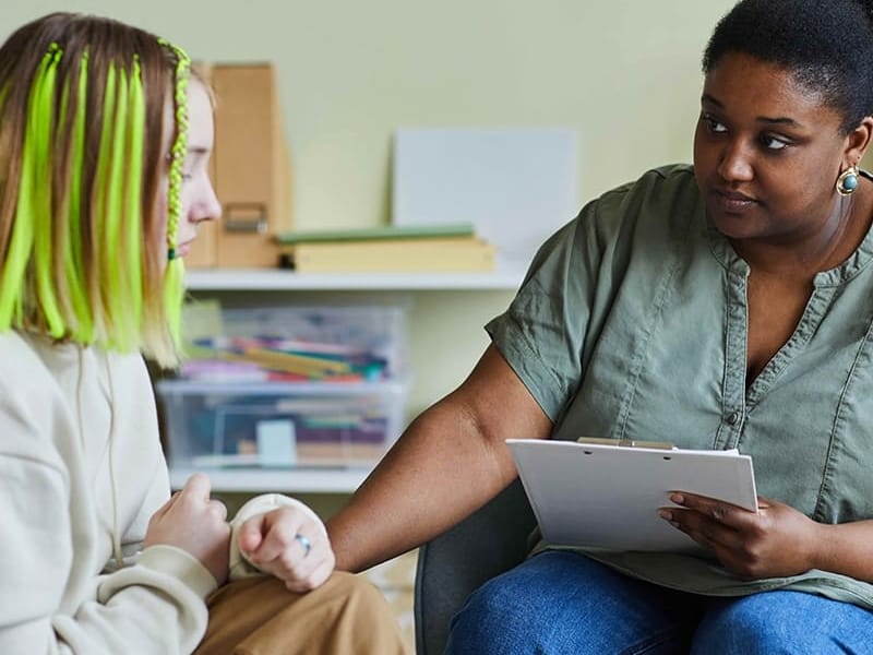 Education Case Manager speaking to a young adult.