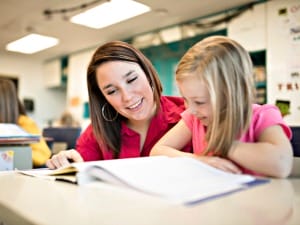 A picture of a teacher supporting a student.